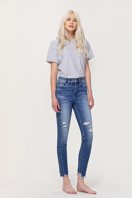 HIGH RISE ANKLE SKINNY W UNEVEN HEM DETAIL